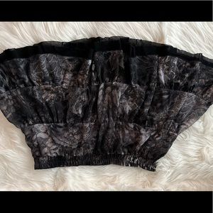 Black mini skirt with silver and gold accent .